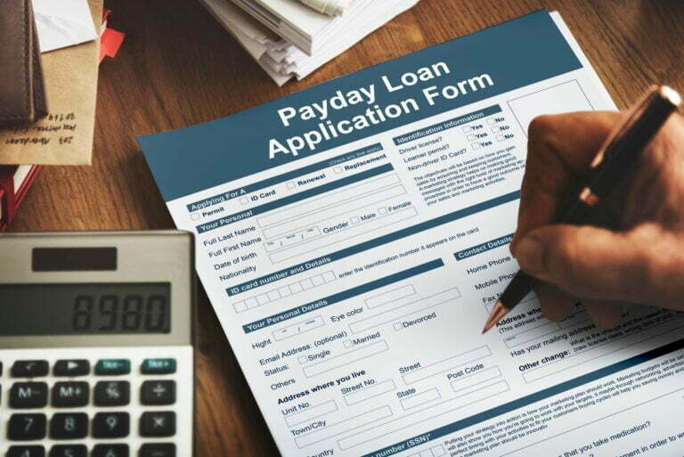 person filling a payday loan application form