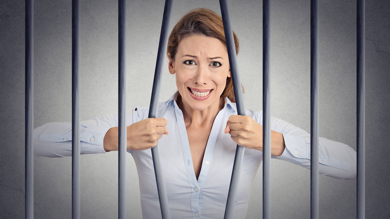 Woman stuck behind bars.